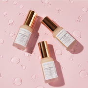 Three bottles of Farmacy's Honeymoon Glow laying next to each other
