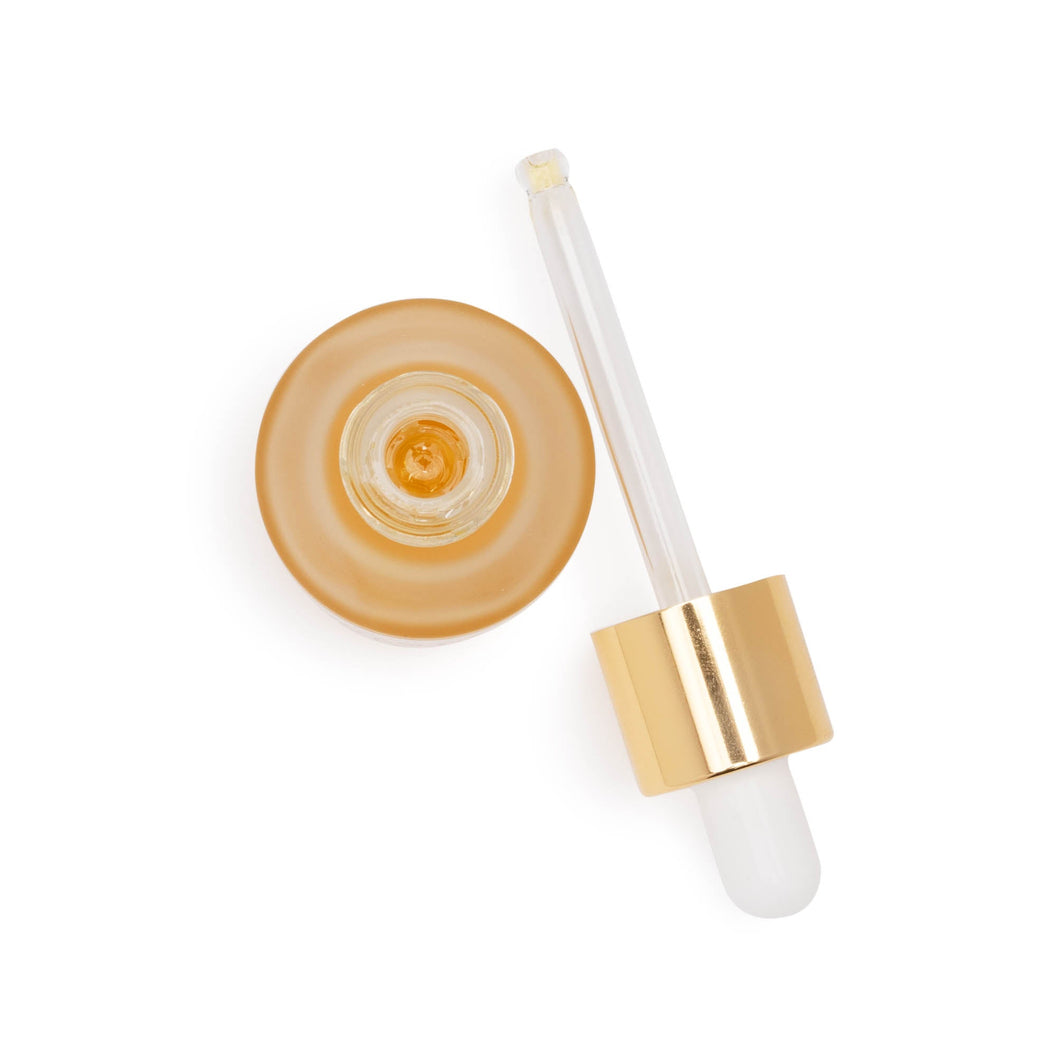 An aerial view of a bottle of Farmacy Honey Grail Hydrating Face Oil