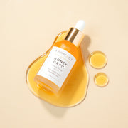 A bottle of Farmacy's Honey Grail laying on top of top of a smear of the antioxidant facial oil