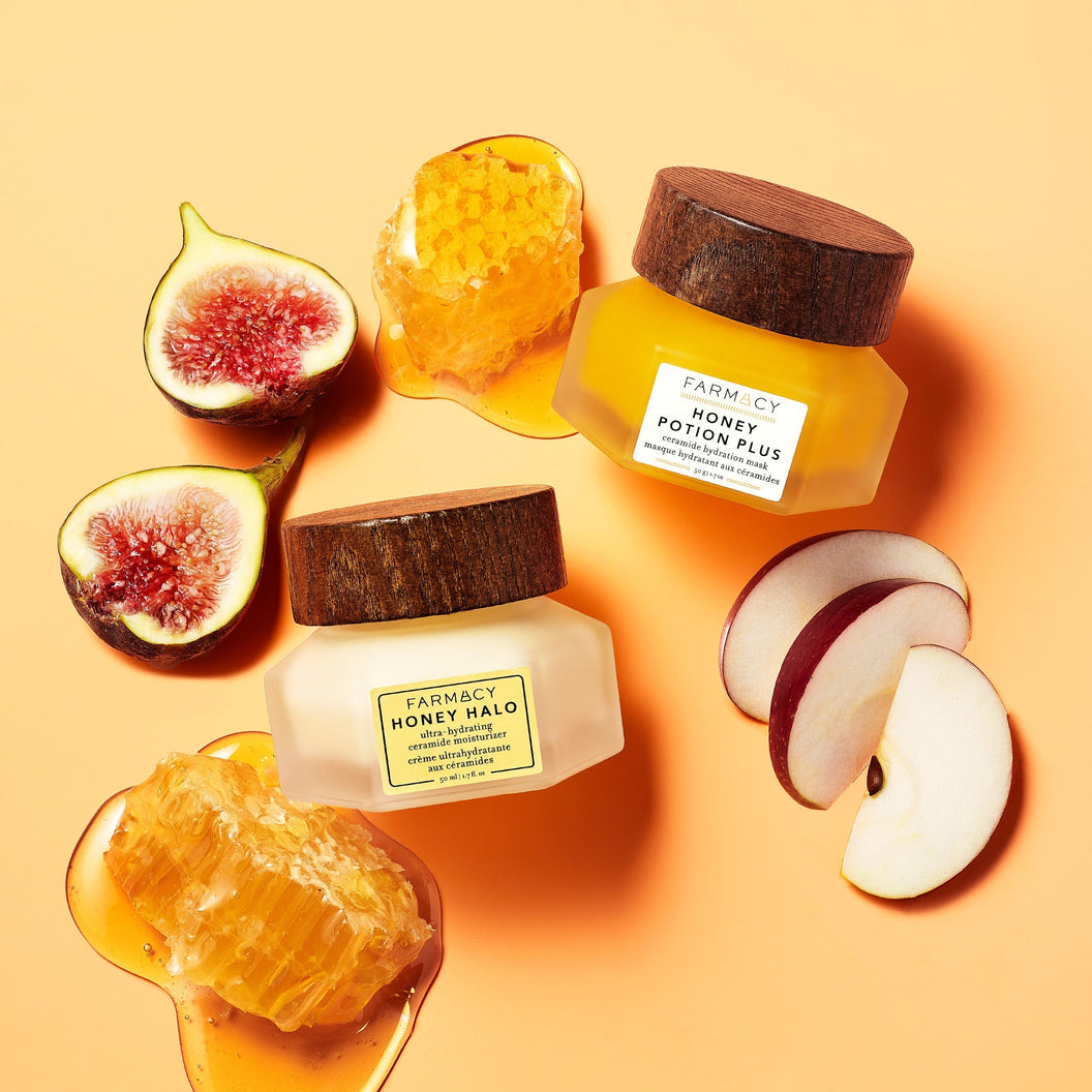 The Honey Halo and Honey Potion Plus sitting next to each other with honey, apple and fig fruit in the background